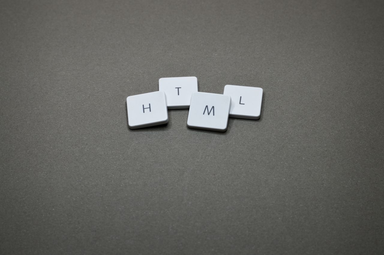 gallery-4 Minimalist image of HTML keycaps against a gray background, perfect for digital and web design themes.